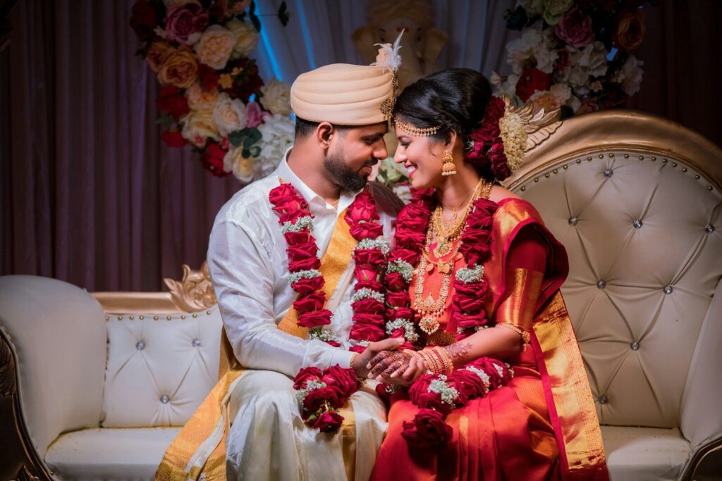 A bride and groom in traditional indian wedding attire.